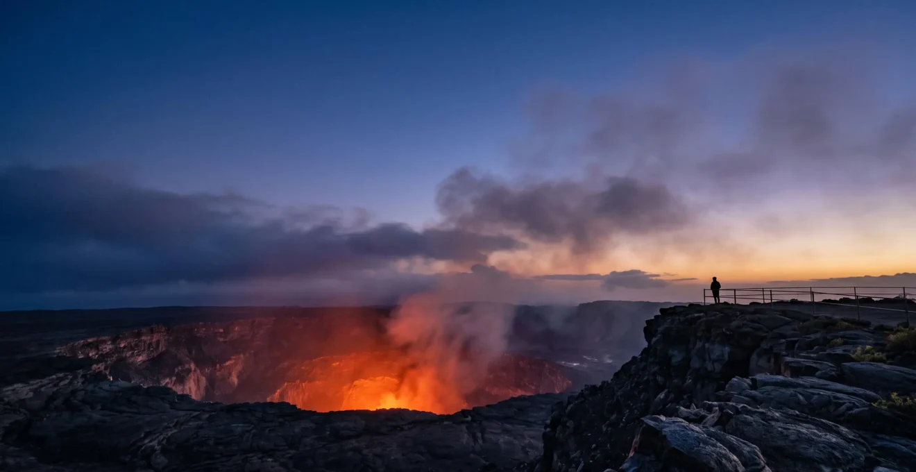 Wide editorial view of a glowing volcanic crater under a twilight sky in Hawaii Volcanoes National Park